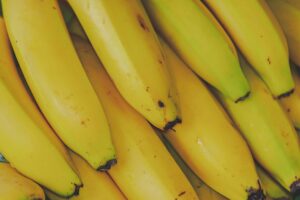 Vibrant and fresh close-up of yellow bananas, highlighting their ripe texture and appeal.