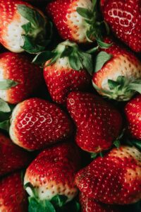 Vibrant close-up image showcasing fresh ripe strawberries, highlighting their rich color and juicy texture.